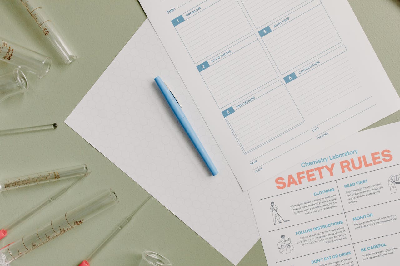 Flat lay of chemistry lab setup with safety rules and experiment notes.